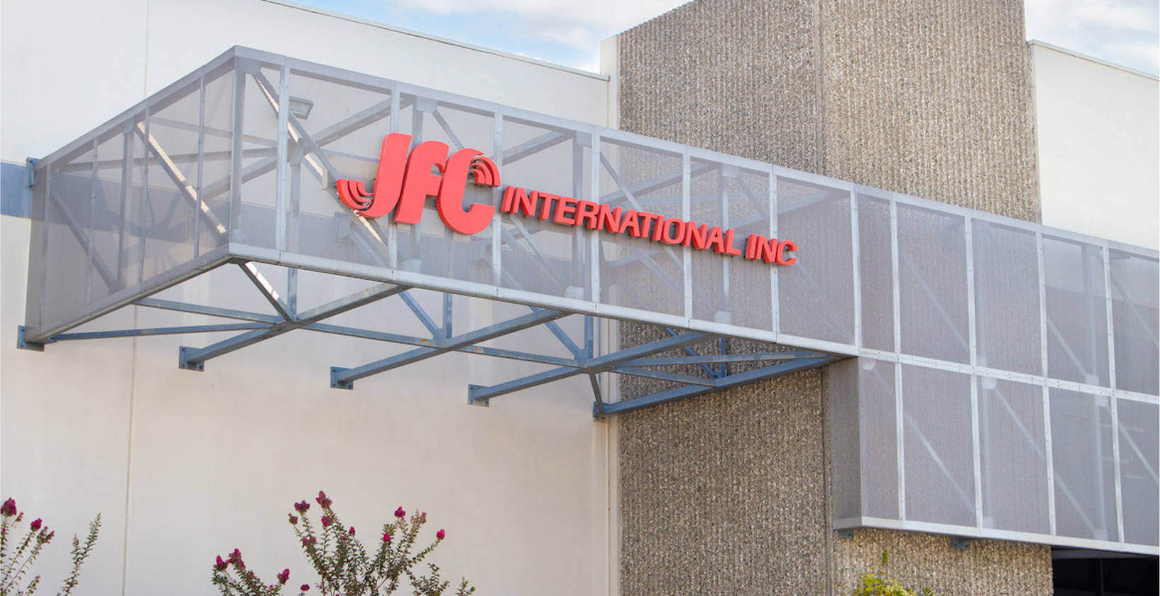 JFC International Inc. facility exterior with covered walkway and red signage