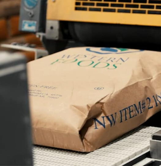 Western Foods branded paper bag on a packaging line conveyor